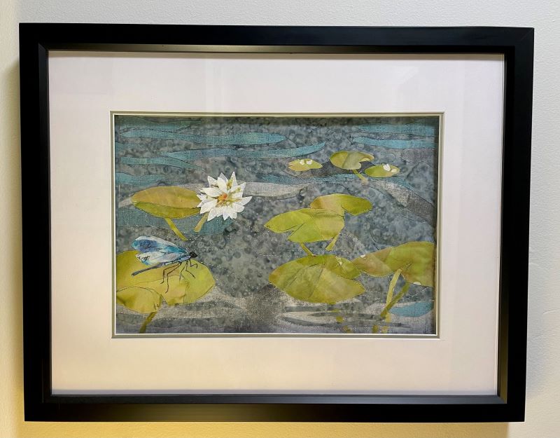 A framed quilted piece of lily pads by Kori Deller.